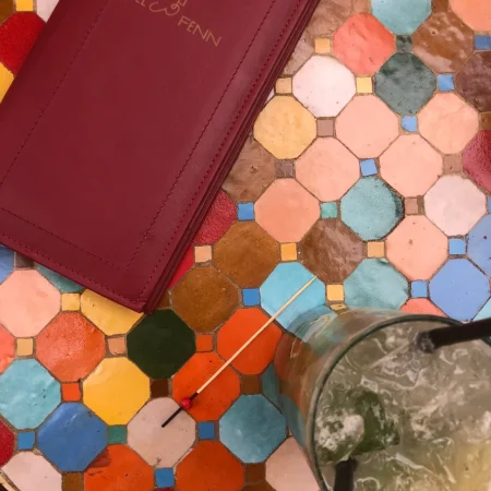 El Fenn menu and cocktail on a colorful mosaic table